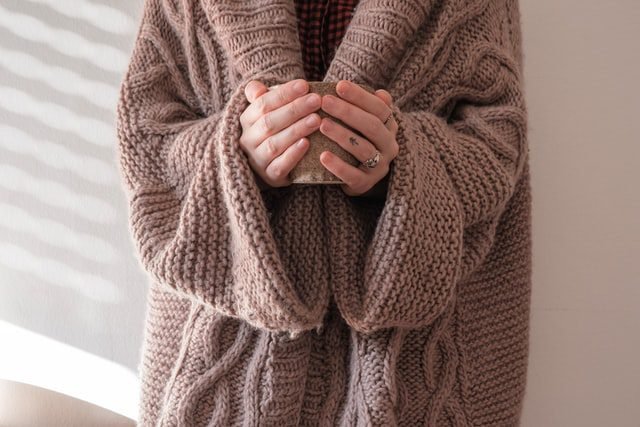 Hands holding a mug