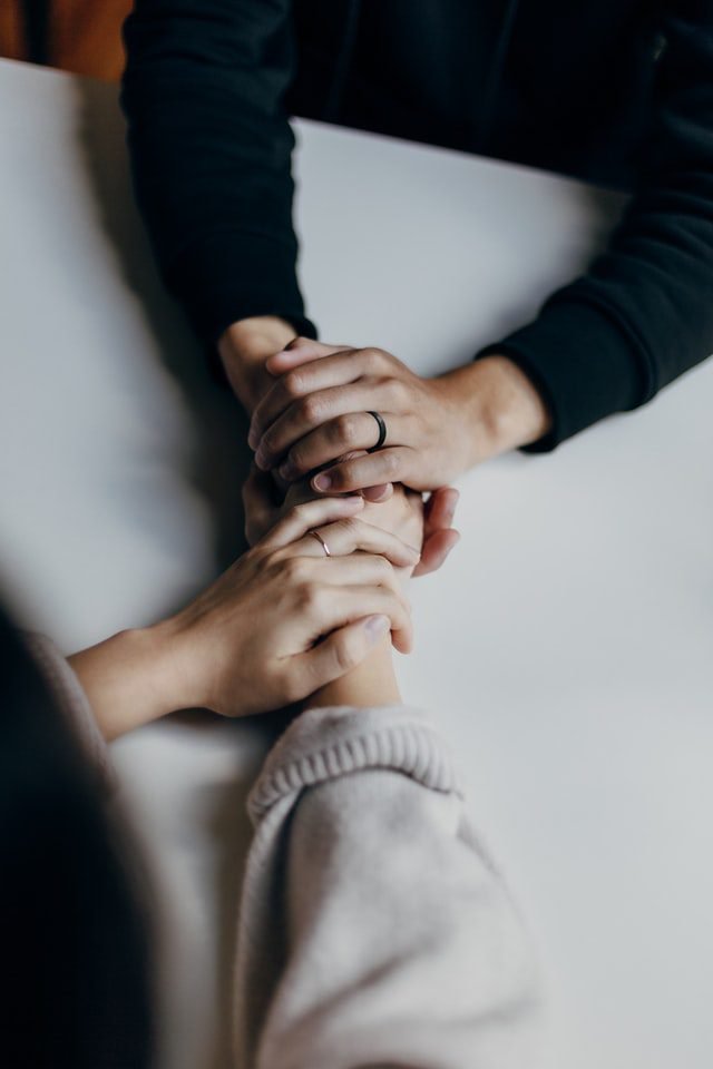 Two people clasping hands